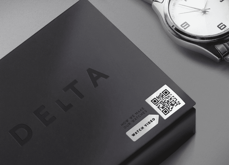 An example of a QR Code on product packaging for a watch that directs readers to a video where they can see how the brand manufactures its watches