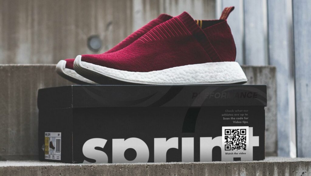 Video QR Code on a shoe box prompting people to scan and watch what their athletes are up to