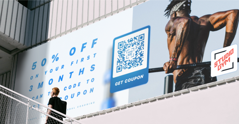 A billboard for a gym with a QR Code on it advertising a coupon for membership
