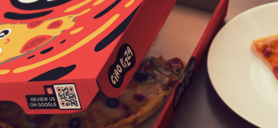 The side of a pizza box with a Google review QR Code.