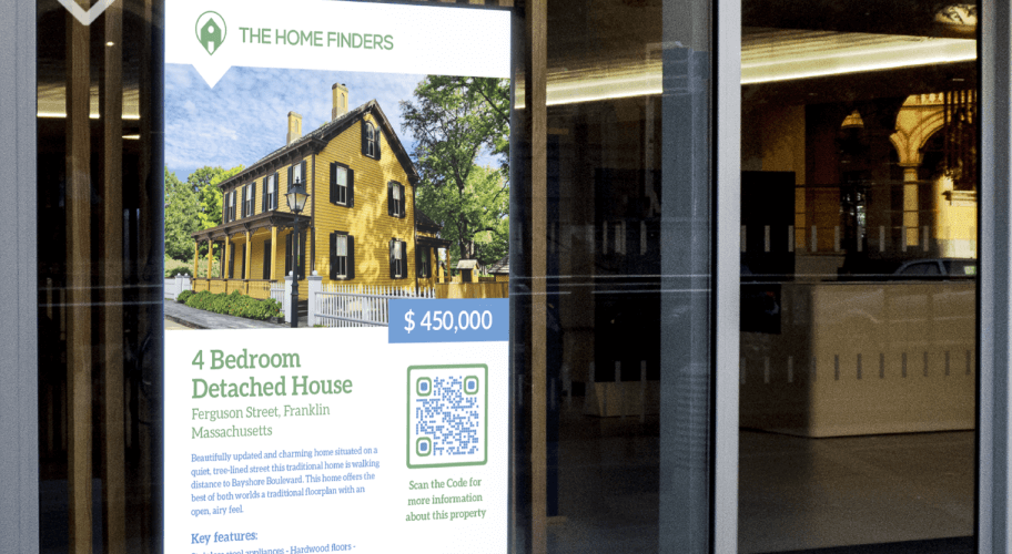A display in a window advertising a home for sale. A QR Code provides potential buyers with more information.