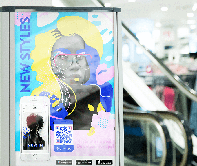 A clothing store banner with a QR Code that links to an app from the Apple App Store, Google Play store, and Amazon Appstore on one page.