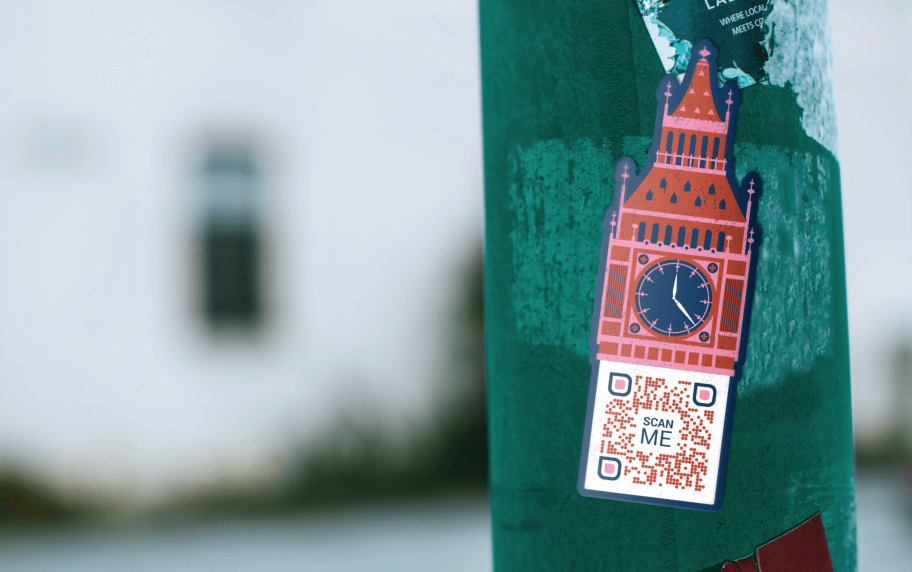 A red, pink, and blue sticker of a building landmark with a QR Code below it placed on a bottle.