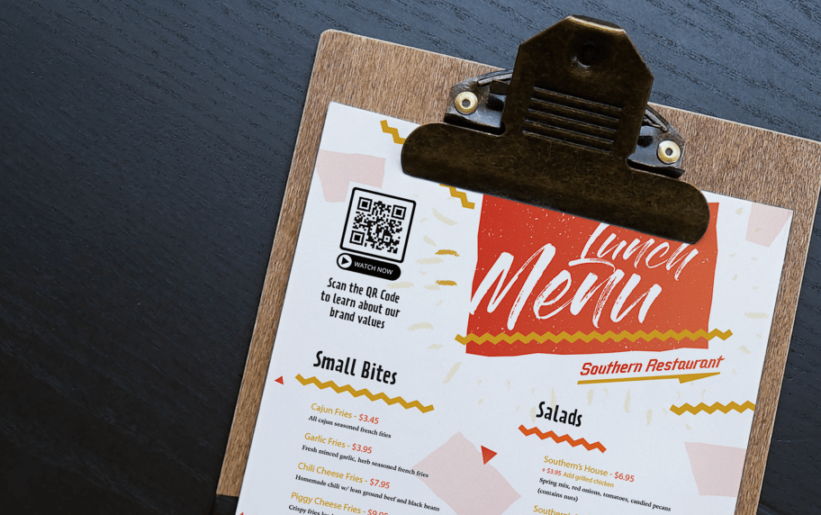 A white, orange, and yellow lunch menu that displays meals and a black and white QR Code in the left-hand corner.