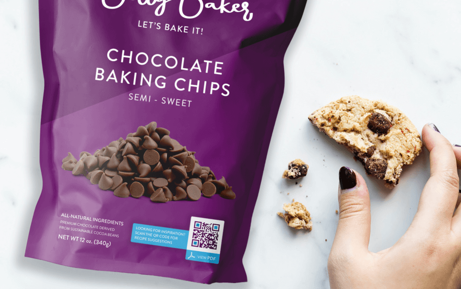 A purple package displaying chocolate chips displayed a QR Code next to a hand holding a half-eaten chocolate chip cookie.