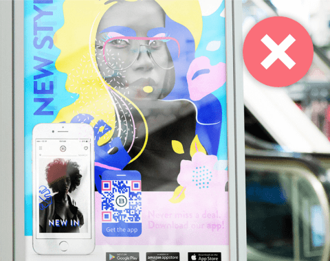 A billboard advertisement with a smartphone and QR Code next to it, next to a red cross mark.