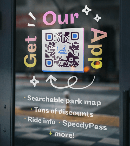 Amusement Park's QR Code on a window display prompting people to scan and get their app.