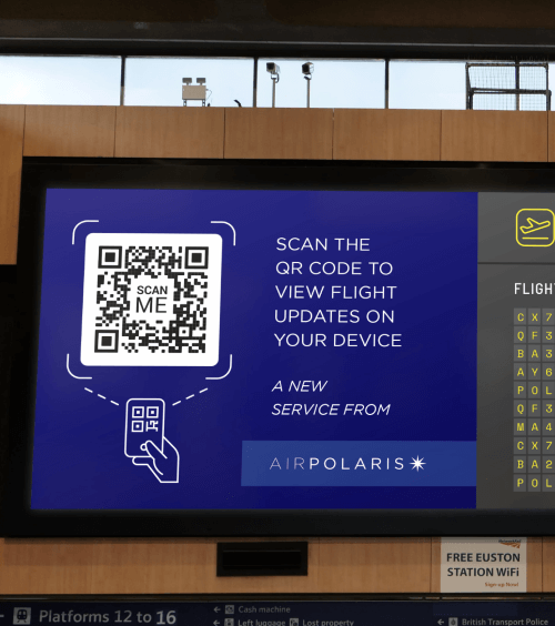 QR Code on an airport departures board prompting people to scan to view flight updates on their mobile phones.