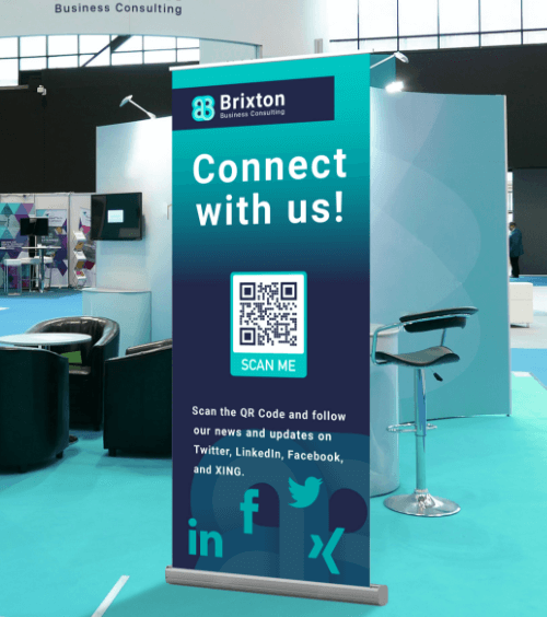 A banner of a business consulting firm at a conference with a QR Code that lists the company’s social media channels.
