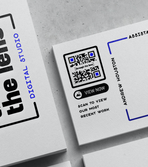 A business card of a photographer with a QR Code that displays images of photography works.